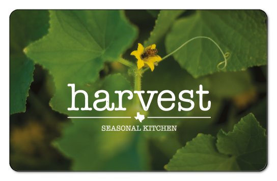 Harvest logo over green leaves off stem